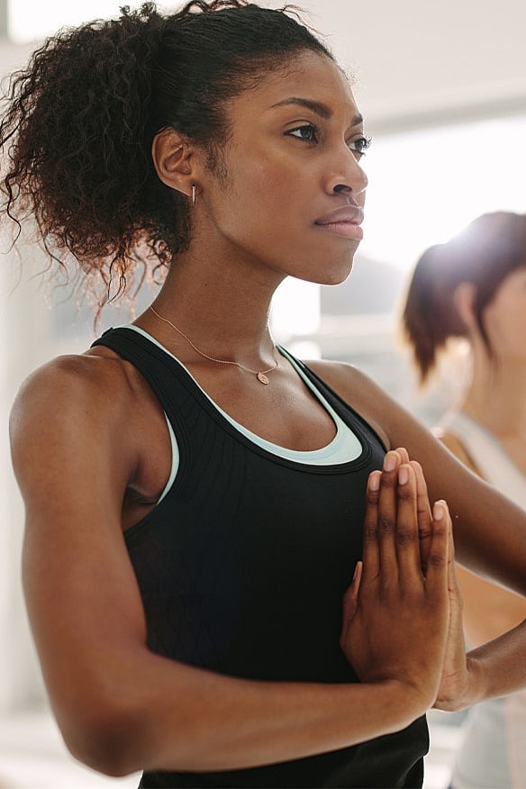 Woman exercising on workout equipment in gym.