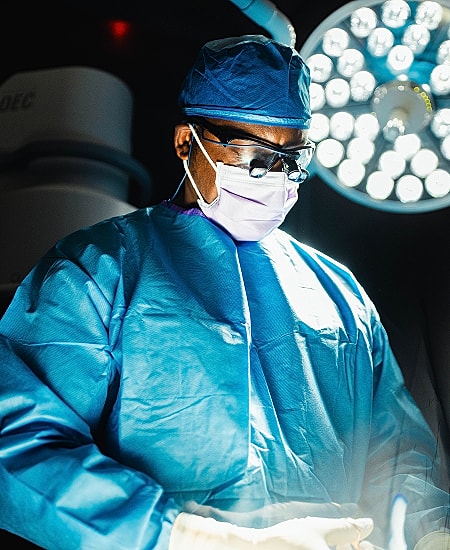 spine surgeon focused on procedure in operating room.