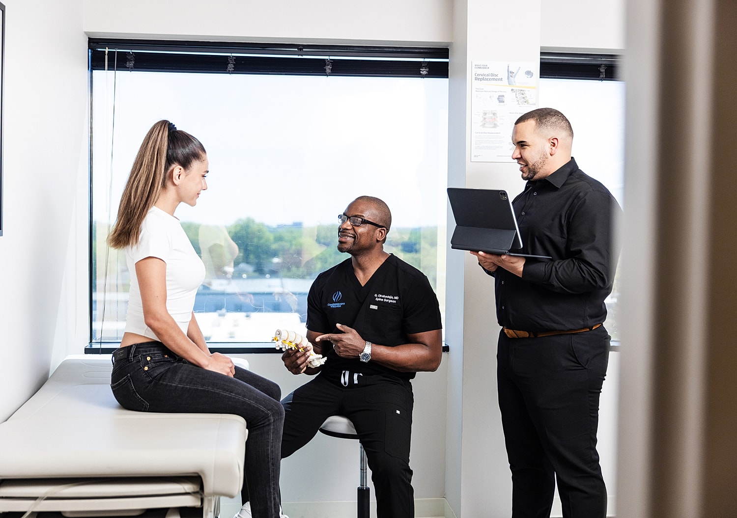 Doctor discussing treatment plan with patient and assistant.