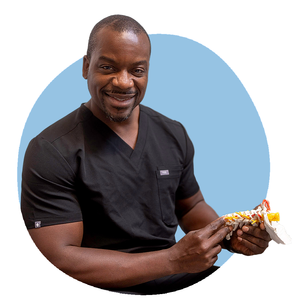 spine surgeon pointing to a medical spine model