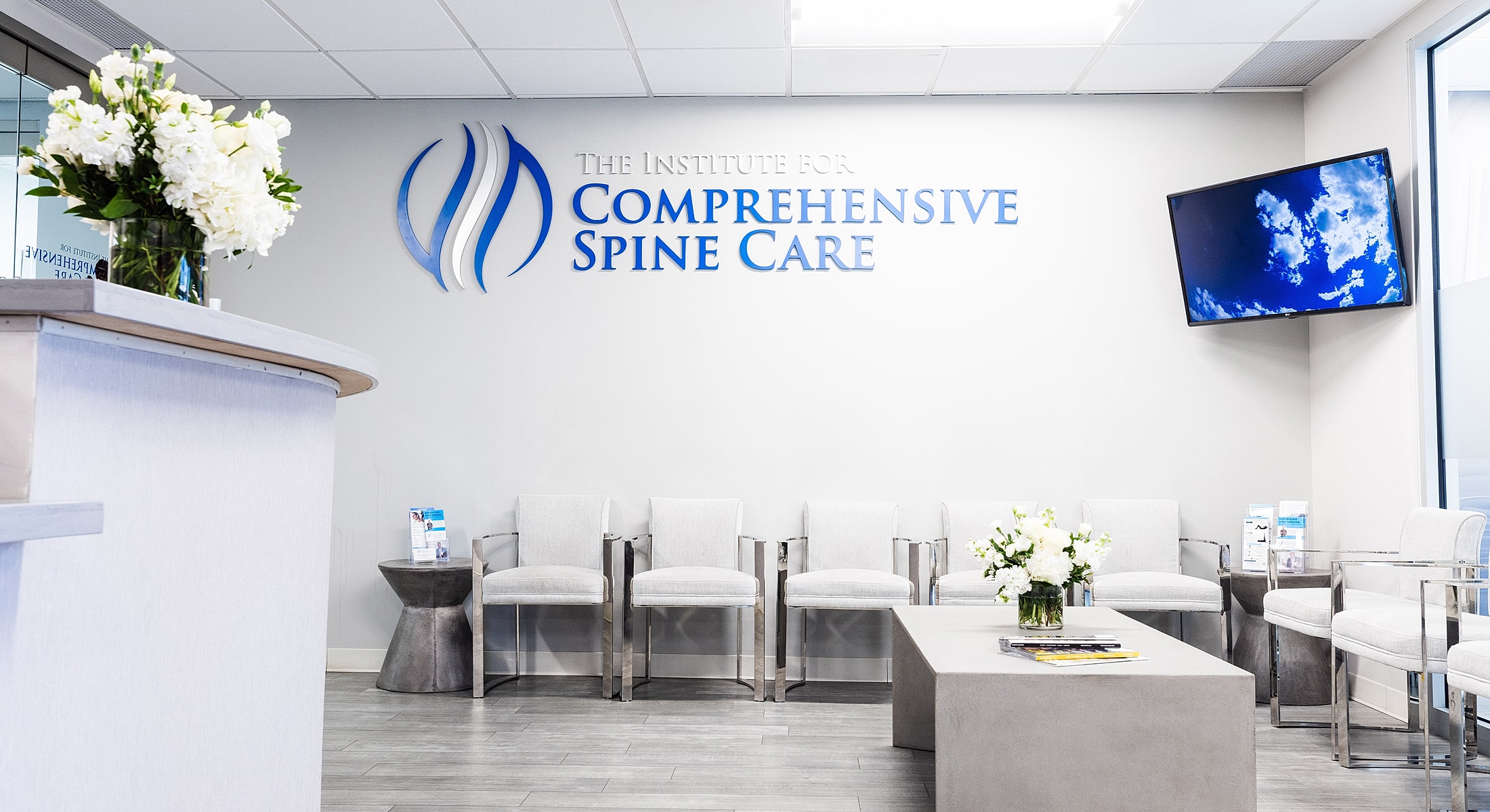 Modern spine care clinic interior with seating.