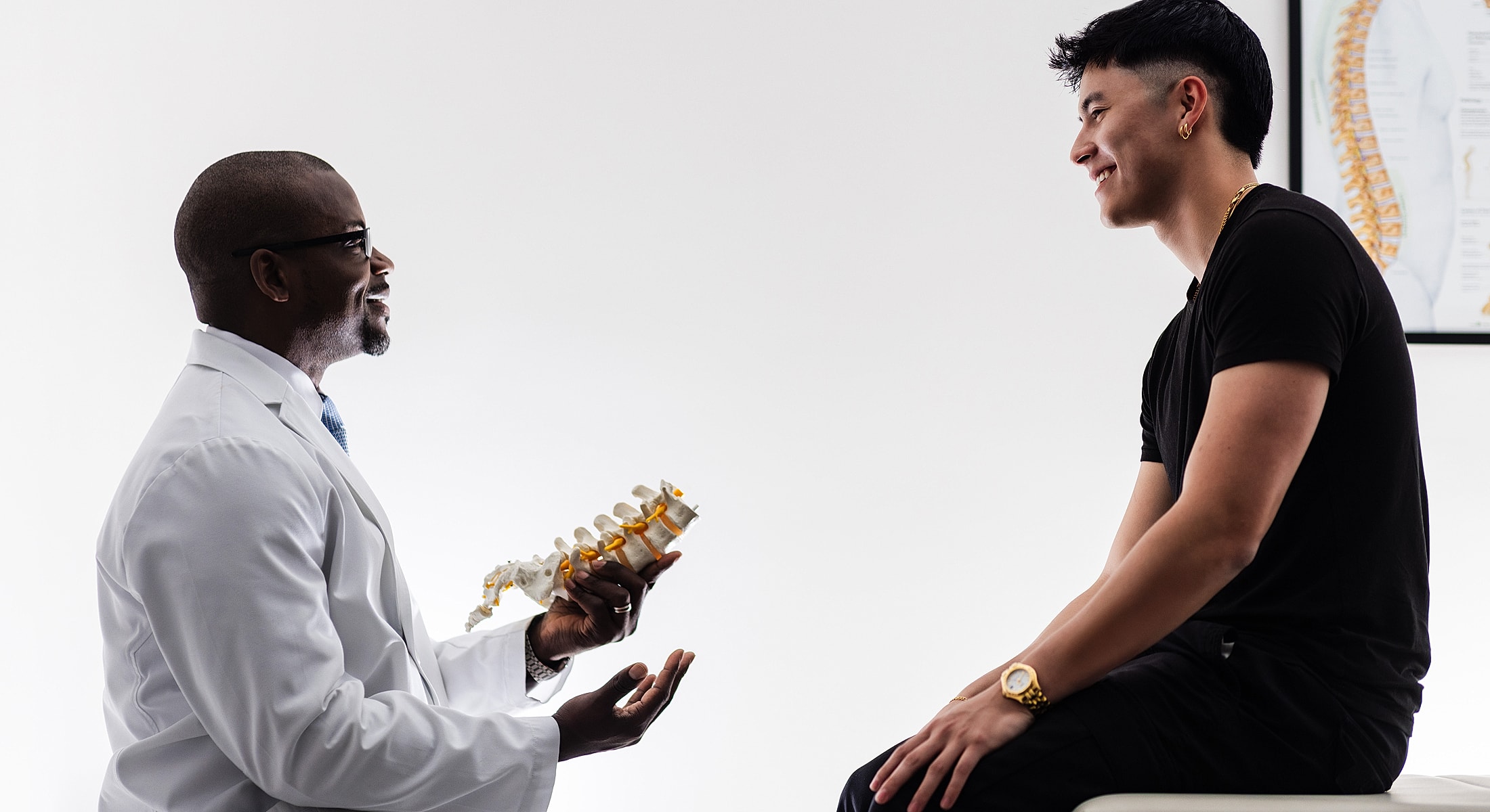 degenerative disc treatment doctor explaining spine model to patient.